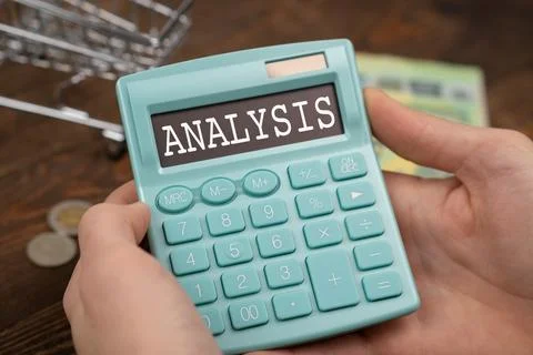 Text Analysis lying on the calculator in hand. Magnifying glass with green .. Stock Photos