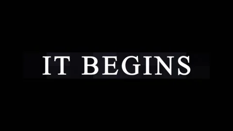 Text animation IT BEGINS appearing on a black background with subtle lighti.. Video stock 344036874