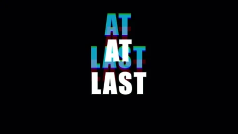 Text animation 'At Last' appears with glitch effect during a subtle zoom ou.. Stock Footage 344035156