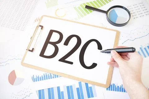 Text B2C on white paper sheet and marker on businessman hand on the diagram.  Stock Photos