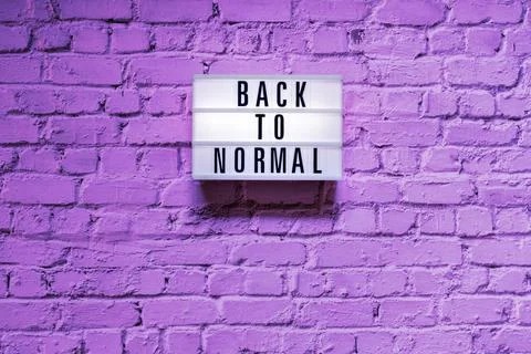 Text Back to normal in lightbox on brick wall Stock Photos