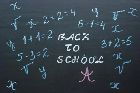 Text Back to school and mathematical examples on black chalkboar Stock Photos