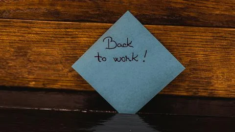 Text Back to work on post it. Writing on sticky note. Copy space. Bucharest.. Stock Photos
