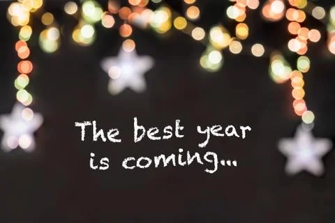 Text the best year is coming in black background with blurred colorful stars Stock Illustration
