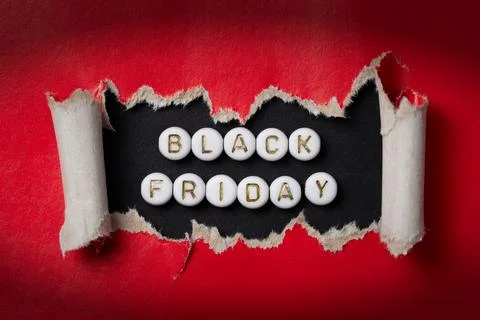 Text "Black Friday" made of beads on a red background. Stock Photos