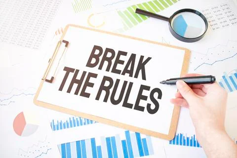 Text Break the Rule son white paper sheet and marker on businessman hand on t Stock Photos