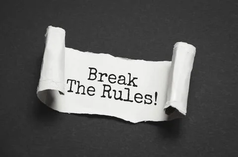The text Break the rules appearing behind torn brown paper Stock Photos