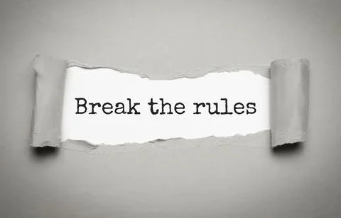 The text Break the rules appearing behind torn brown paper Stock Photos