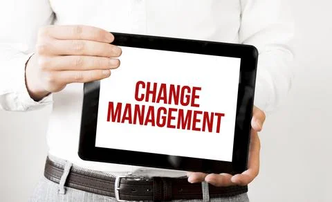 Text CHANGE MANAGEMENT on tablet display in businessman hands on the white ba Stock Photos