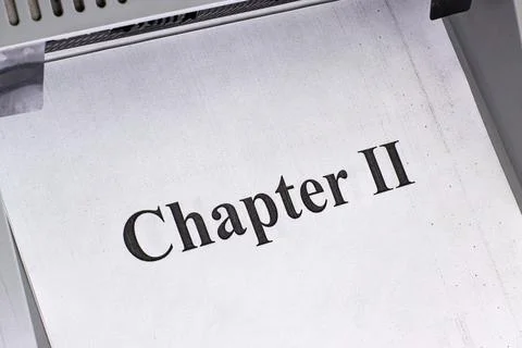 Text from chapter two printed on white paper with a printer in action without Stock Photos