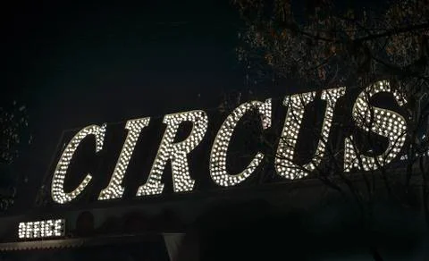 Text circus in the night. Circus office illuminated. Stock Photos