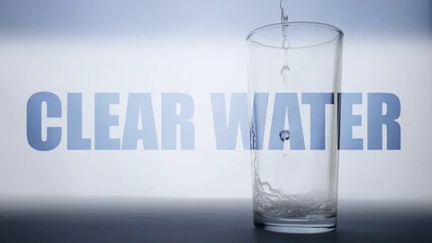 Text Clear Water. An empty glass is filling with water Stock Footage 112124631