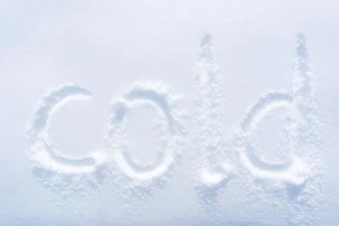 Text "COLD" made with your finger in the snow. Top view Stock Photos