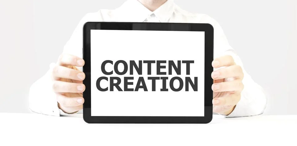 Text CONTENT CREATION on tablet display in businessman hands on the white b.. Stock Photos