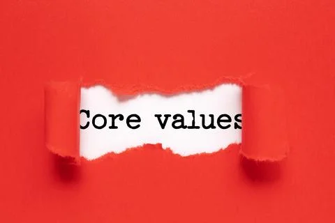 The text CORE VALUES appearing behind torn red paper Stock Photos