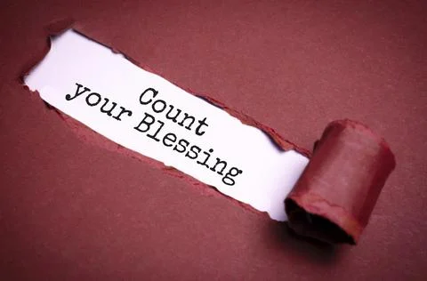 The text count your blessing appearing behind torn brown paper Stock Photos