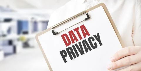 Text data privacy on white paper plate in businessman hands in office. Busine Stock Photos