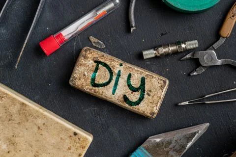 The text of DIY do it yourself sign on the plate with some accessories around Stock Photos