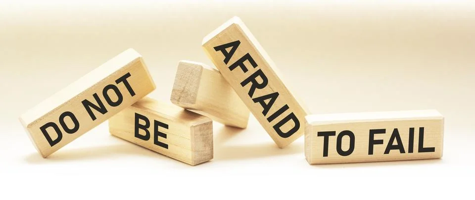 Text DO NOT BE AFRAID TO FAIL text on wooden blocks and white background. Mot Stock Photos