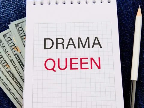 Text DRAMA QUEEN in a notebook in a composition with American hundred dollar  Stock Photos