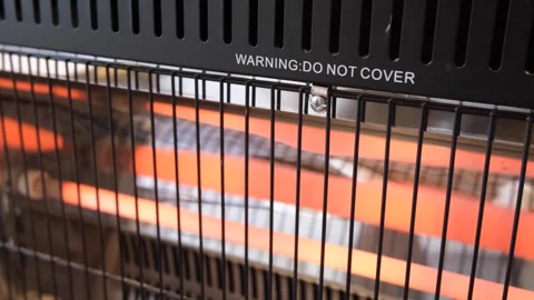 Text in Englishthat says ‘Warning Do Not Cover’ on a electronic heater Vídeo Stock 246054710
