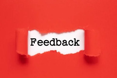 The text feedback appearing behind torn red paper Stock Photos