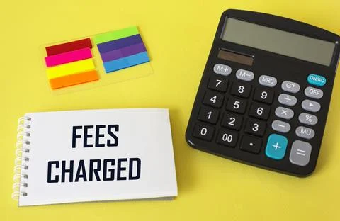 Text FEES CHARGET, next to stickers and calculator on yellow background Stock Photos