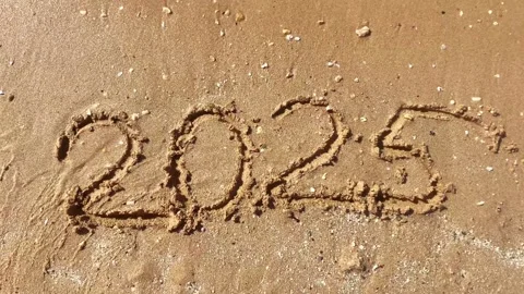 Text figures 2025 handwritten numbers by tourists on golden sandy beach surface, Stock Footage 320884718