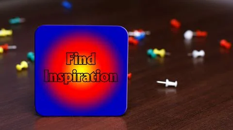 Text FIND INSPIRATION on the background of the table and scattered pushpins Stock Photos