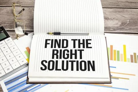 Text Find The Right Solution on brown diary with calculator, glasses on woode Stock Photos