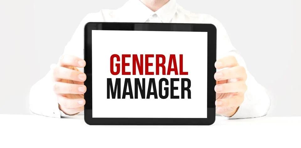 Text GENERAL MANAGER on tablet display in businessman hands on the white bakc Stock Photos