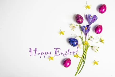 Text Happy Easter. Colorful easter eggs and flowers crocus isolated on a white 写真素材