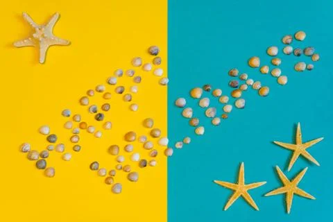 Text "Happy Holidays" made of small seashells on yellow and blue paper backgr Stock Photos