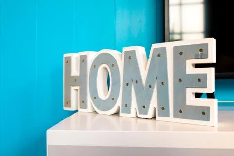 Text "HOME" on a blue background. Stock Photos