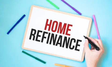 Text Home refinance on a notebook surrounded by colored felt-tip pens, busine Stock Photos