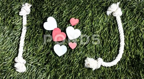 Text: I love J made from ropes on grass background. Stock Photos