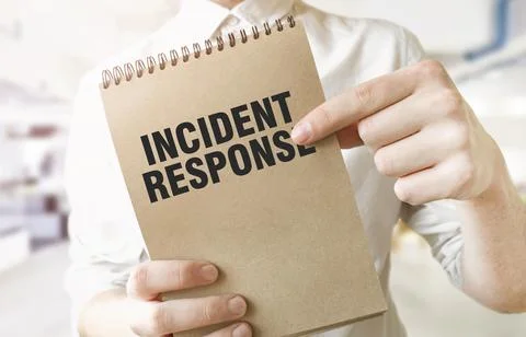 Text INCIDENT RESPONSE on brown paper notepad in businessman hands in offic.. Stock Photos