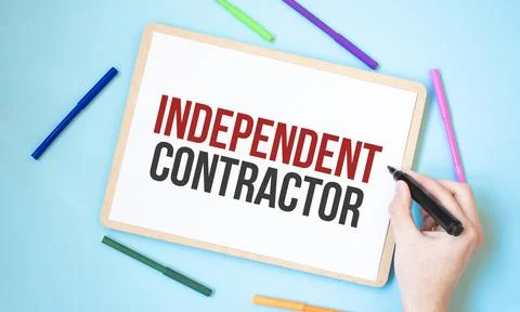 Text independent contractor on a notebook surrounded by colored felt-tip pens Stock Photos
