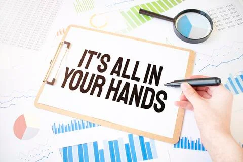 Text It's all in your hands on white paper sheet and marker on businessman ha Stock Photos
