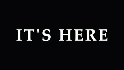 Text IT'S HERE animated with glitch effects during a dark abstract transiti.. Video stock 344037269