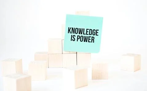 Text Knowledge is power writing in green card cube ladder. White background.  Stock Photos