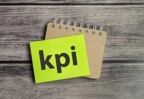 Text KPI on paper with notepad and wooden background Stock Photos