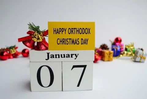 Text label and cube 7th January with blurred christmas ornament background Stock Photos