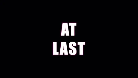Text AT LAST appearing with light rays during a cinematic reveal against a .. Video stock 344035326