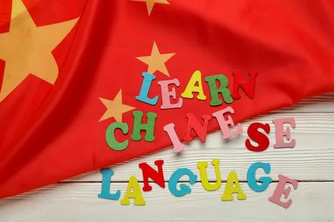 Text LEARN CHINESE LANGUAGE with flag on white wooden background Stock Photos