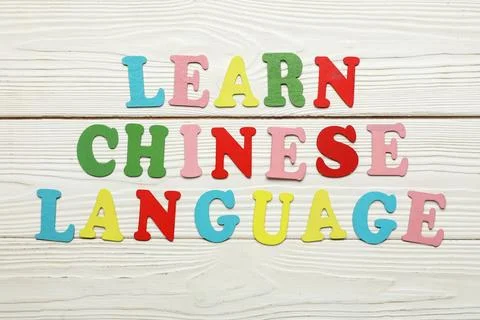 Text LEARN CHINESE LANGUAGE on white wooden background Stock Photos