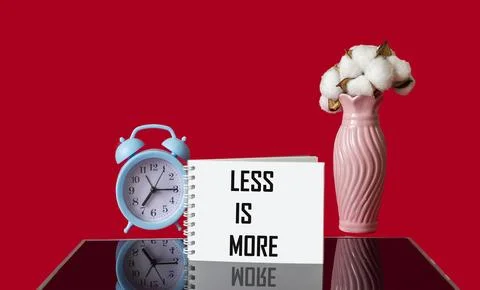 Text Less is more scale concept on red and black background. Stock Photos