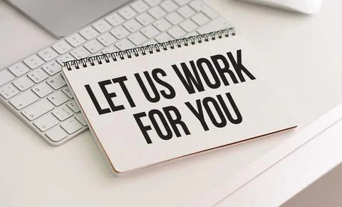 Text Let us work for you on notebook page on wooden table in office workspa.. Stock Photos