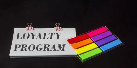 The text Loyalty program is written on a sticker, next to the colored sticker Stock-Fotos