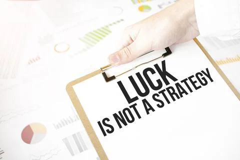 Text Luck is not A Strategy on white paper plate in businessman hands with fi Stock Photos